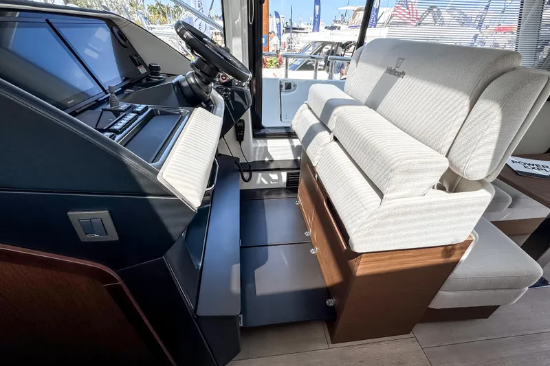 Slide: The Image of Interior of 2026 Wellcraft 44 Explorer with helm and seating area. - 16