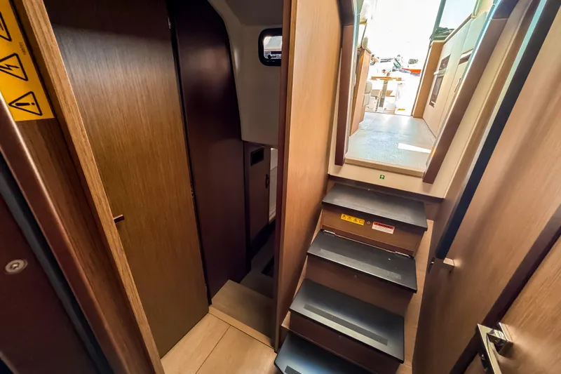 Slide: The Image of Interior of 2026 Wellcraft 44 Explorer with stairs and wooden walls. - 24
