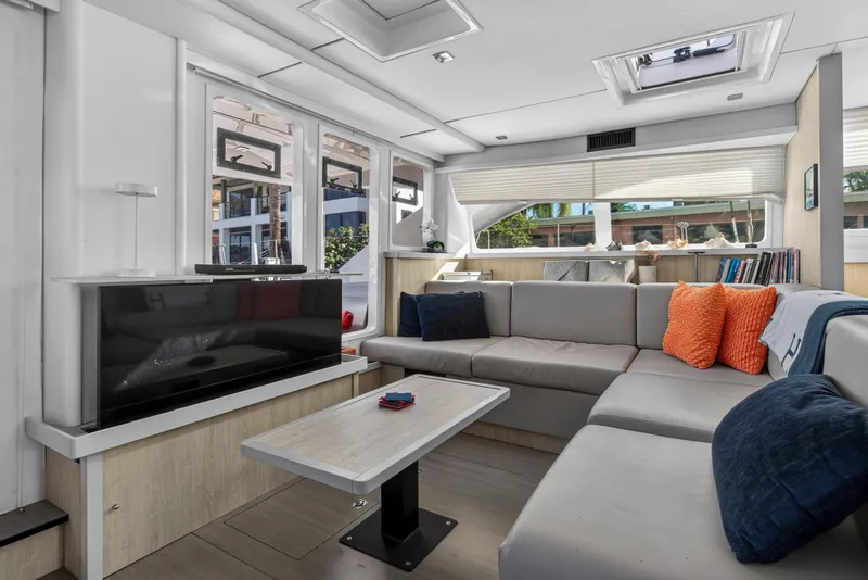 Slide: The Image of Luxurious 2019 Leopard 58 yacht interior with modern seating, TV, and large windows. - 14