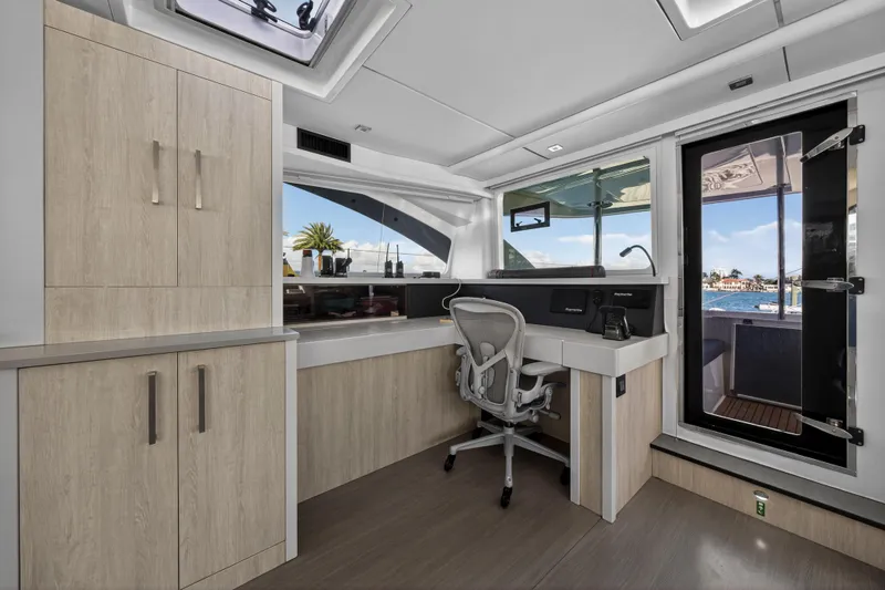 Slide: The Image of Modern interior of 2019 Leopard 58 yacht with sleek desk and ocean view. - 16