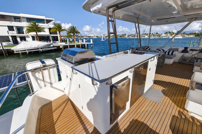 Slide: The Image of Luxurious 2019 Leopard 58 yacht deck with outdoor kitchen, overlooking serene waterfront views. - 20
