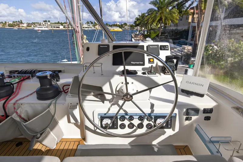 Slide: The Image of Helm of 2019 Leopard 58 yacht with navigation equipment and scenic waterfront view. - 21
