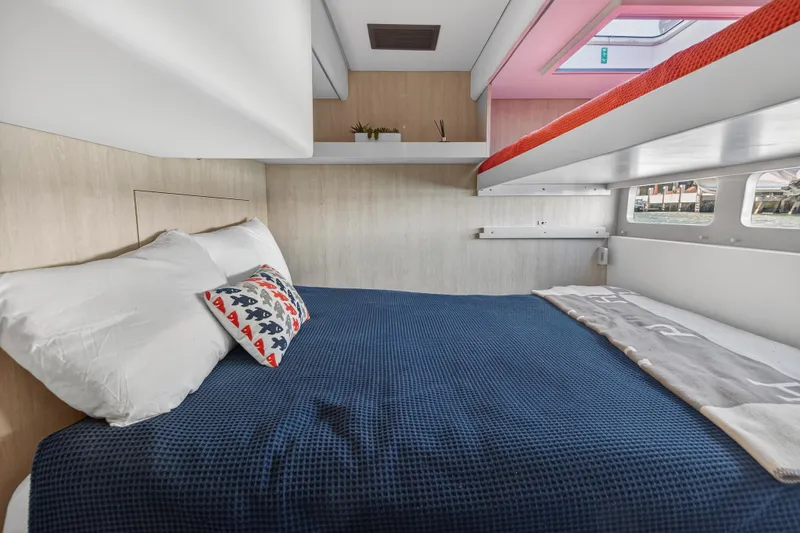 Slide: The Image of Cozy bedroom in 2019 Leopard 58 yacht with blue bedding and decorative pillows. - 25