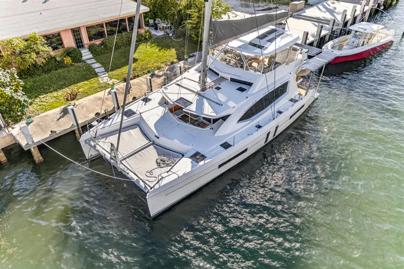 Slide: The Image of Aerial view of 2019 Leopard 58 catamaran docked by a waterfront property. - 36