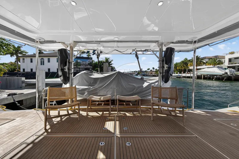 Slide: The Image of Luxury Leopard 58 yacht deck with wooden flooring, chairs, and waterfront view, 2019 model. - 6