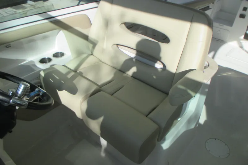 Slide: The Image of 2019 Sailfish 325 DC boat interior with seating, sink, and navigation equipment. - 10