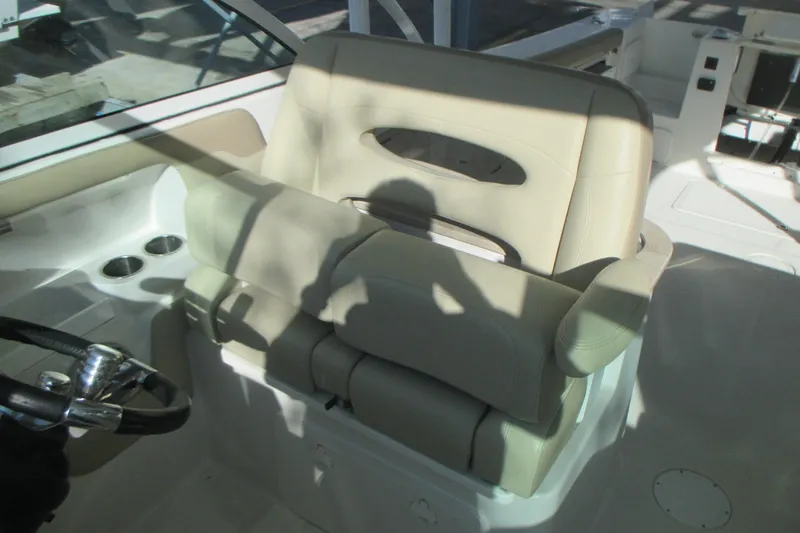 Slide: The Image of 2019 Sailfish 325 DC boat interior with seating, sink, and navigation equipment. - 11