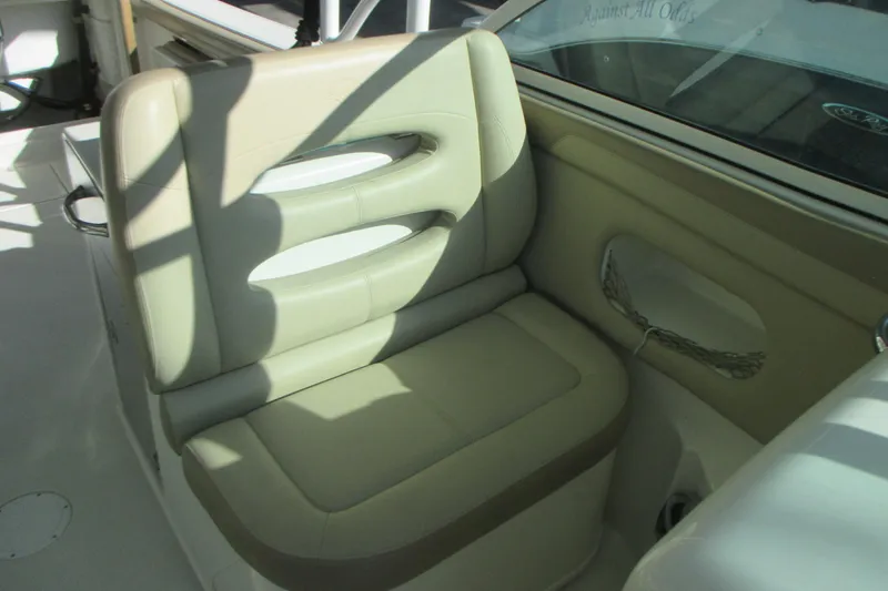 Slide: The Image of 2019 Sailfish 325 DC boat interior with beige seating and steering wheel. - 13