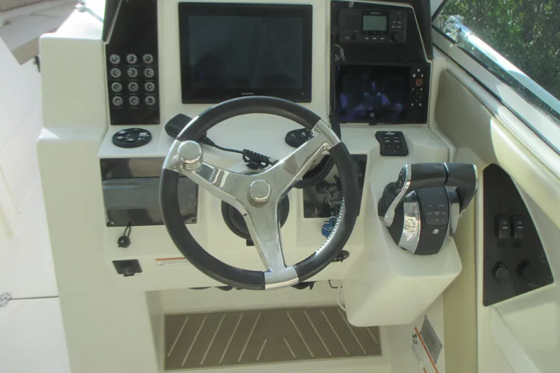 Slide: The Image of 2019 Sailfish 325 DC boat interior with cushioned seating and speaker. - 15
