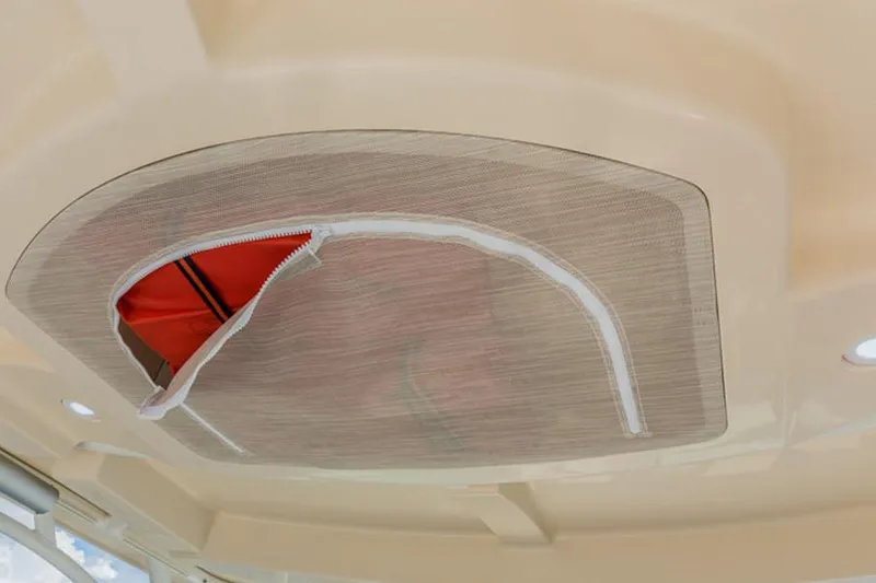 Slide: The Image of 2019 Sailfish 325 DC boat cockpit with steering wheel and control panel. - 19