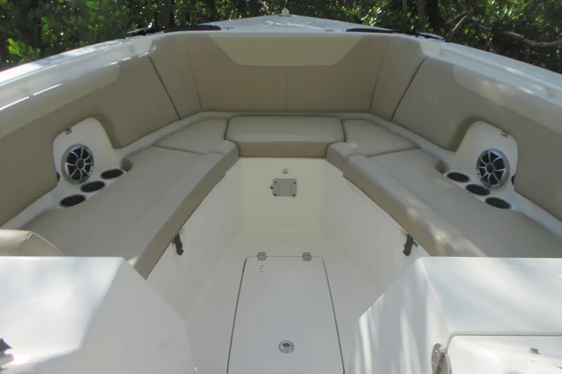Slide: The Image of 2019 Sailfish 325 DC boat interior with sink, storage drawers, and seating area. - 23