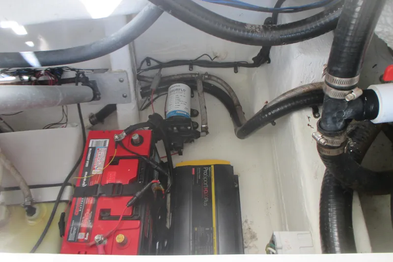 Slide: The Image of 2019 Sailfish 325 DC boat engine compartment with battery and wiring. - 27