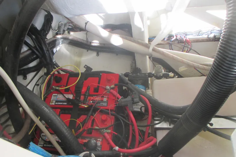 Slide: The Image of 2019 Sailfish 325 DC boat battery compartment with wiring and connections. - 28