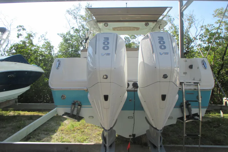 Slide: The Image of 2019 Sailfish 325 DC boat on trailer near waterfront homes. - 5