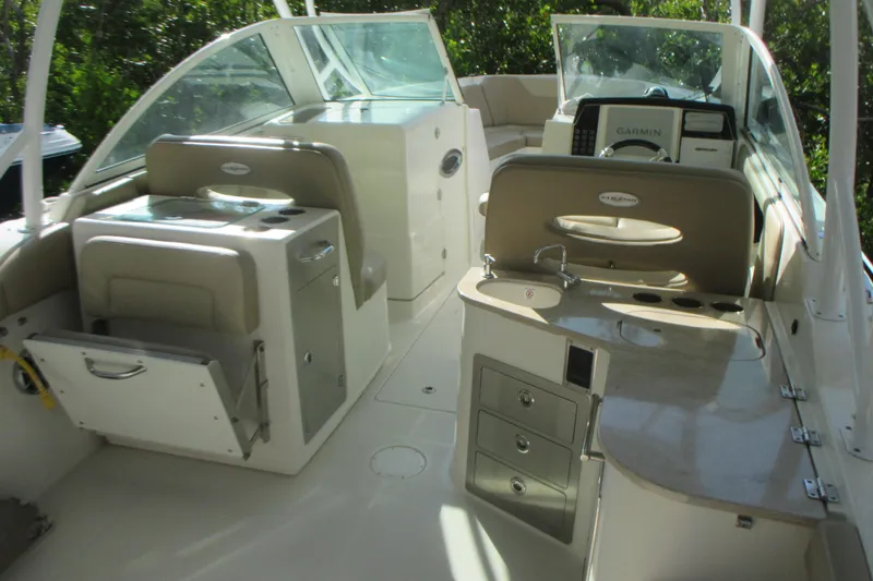 Slide: The Image of 2019 Sailfish 325 DC boat with sleek blue hull in storage. - 7