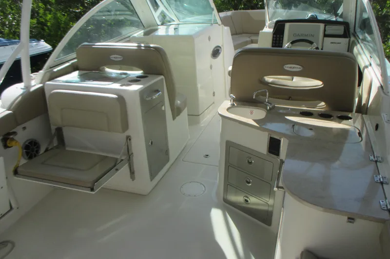 Slide: The Image of 2019 Sailfish 325 DC boat in storage, vibrant blue hull, docked on a rack. - 8