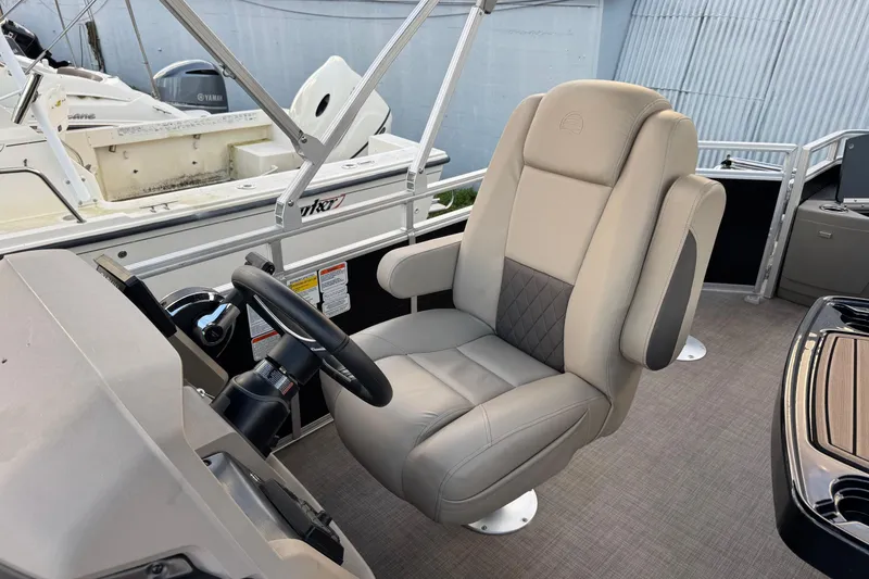 Slide: The Image of 2024 Sun Tracker SportFish 20 DLX captain's chair and steering console, showcasing luxury and comfort. - 12