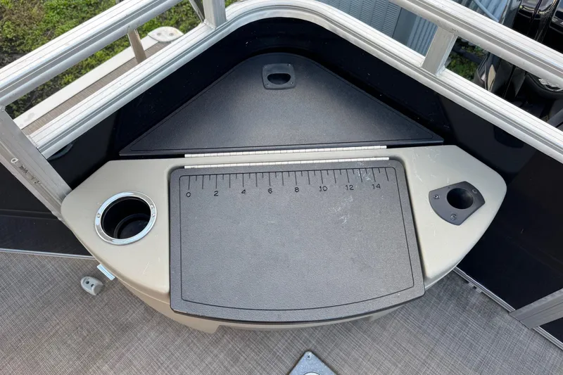 Slide: The Image of 2024 Sun Tracker SportFish 20 DLX fishing station with measuring board and cup holder. - 16