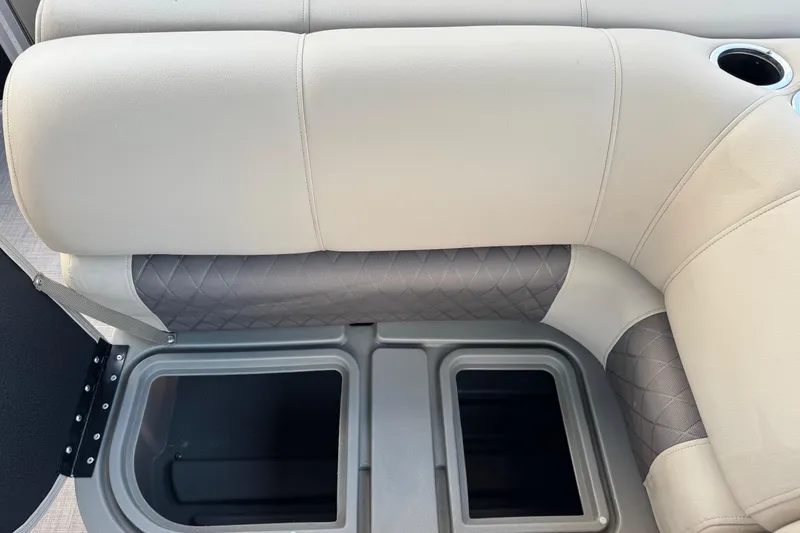 Slide: The Image of 2024 Sun Tracker SportFish 20 DLX boat seating with storage compartments and cup holder. - 18