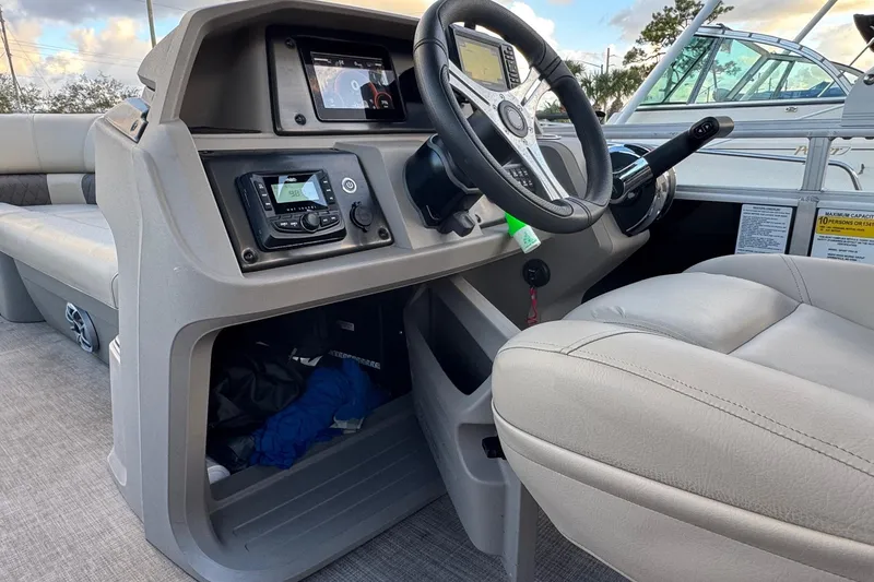 Slide: The Image of 2024 Sun Tracker SportFish 20 DLX boat interior with steering wheel and control panel. - 28