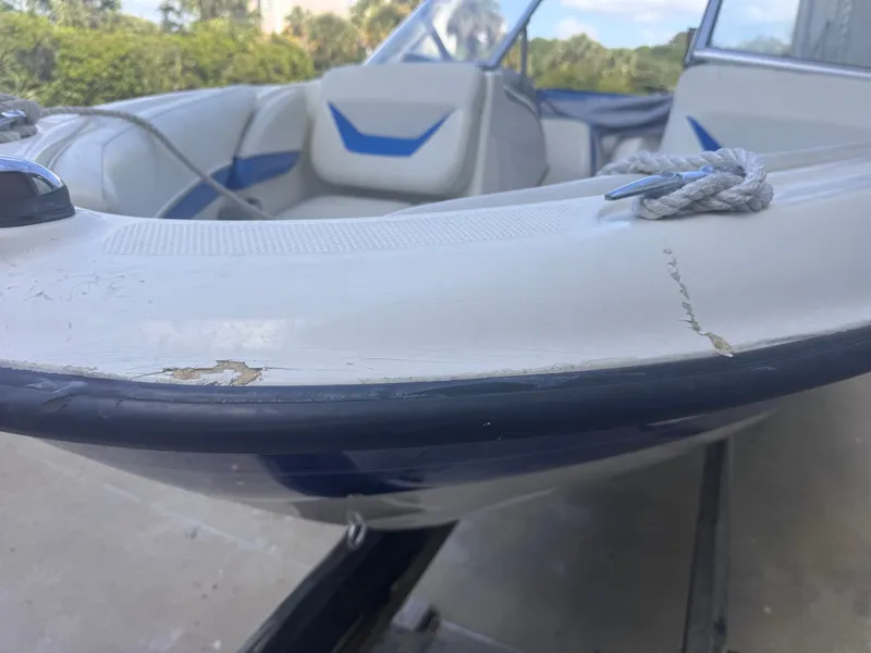 Slide: The Image of Close-up of a damaged 2006 Bayliner 185 boat hull. - 2
