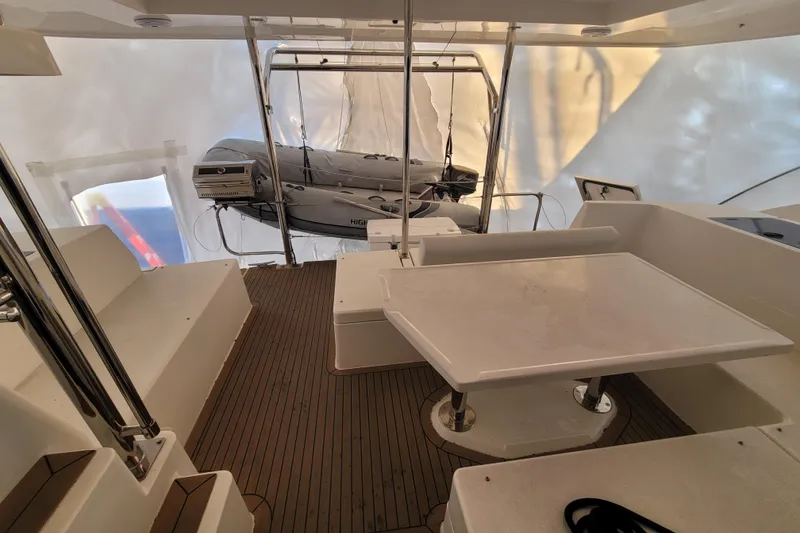 Slide: The Image of 2018 Leopard 40 yacht interior with seating, table, and dinghy on deck. - 29