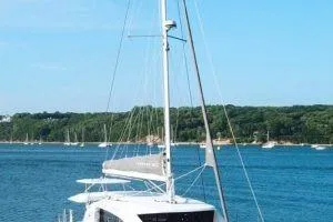 Slide: The Image of 2018 Leopard 40 catamaran sailing on a serene blue lake with forested shoreline. - 3