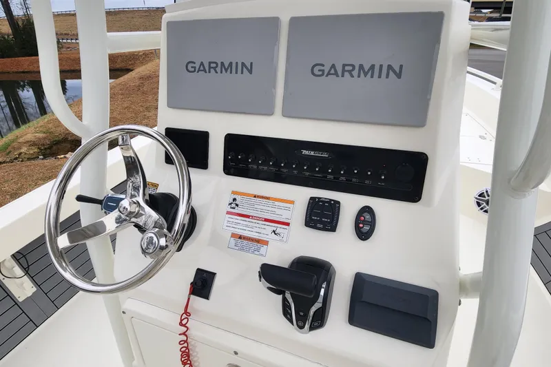 Slide: The Image of 2024 Pathfinder 2600 TRS boat dashboard with Garmin navigation and steering wheel. - 12