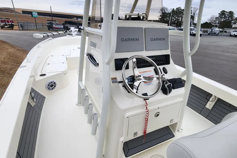 Slide: The Image of 2024 Pathfinder 2600 TRS boat interior with Garmin navigation system and steering wheel. - 13