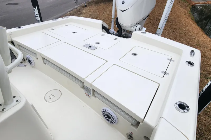 Slide: The Image of 2024 Pathfinder 2600 TRS boat deck with storage compartments and motor. - 17