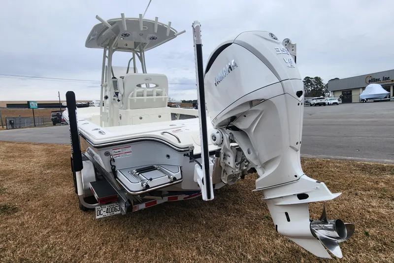 Slide: The Image of 2024 Pathfinder 2600 TRS boat with Yamaha outboard motor, parked on grass. - 4
