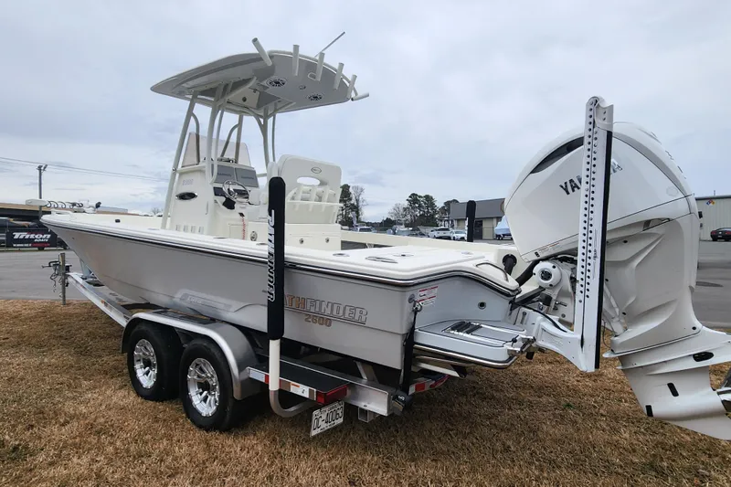 Slide: The Image of 2024 Pathfinder 2600 TRS boat on trailer with Yamaha engine, parked on grass. - 5