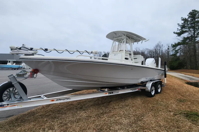 Slide: The Image of 2024 Pathfinder 2600 TRS boat on trailer, side view, outdoors, overcast sky. - 7