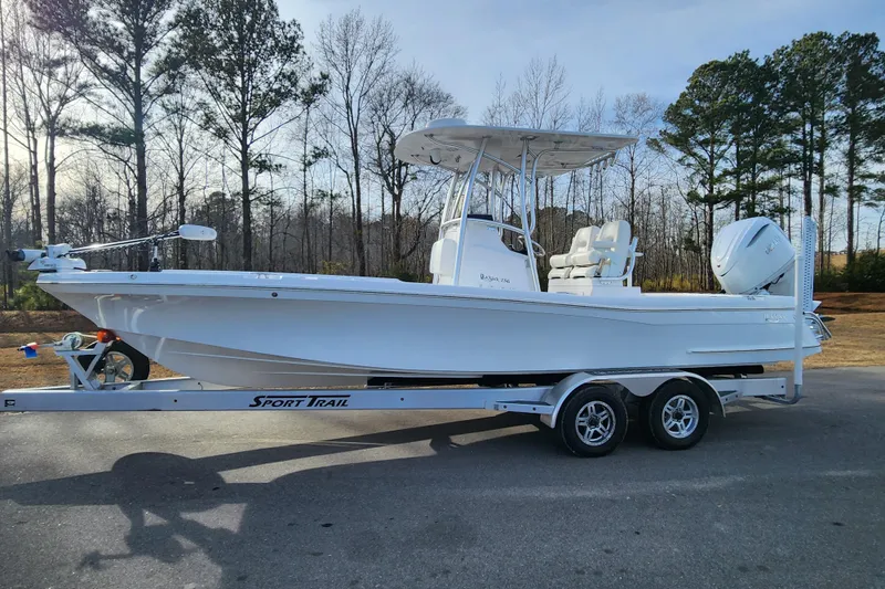 Slide: The Image of 2025 BlackJack 256 Coastal boat on trailer, parked outdoors. - 0