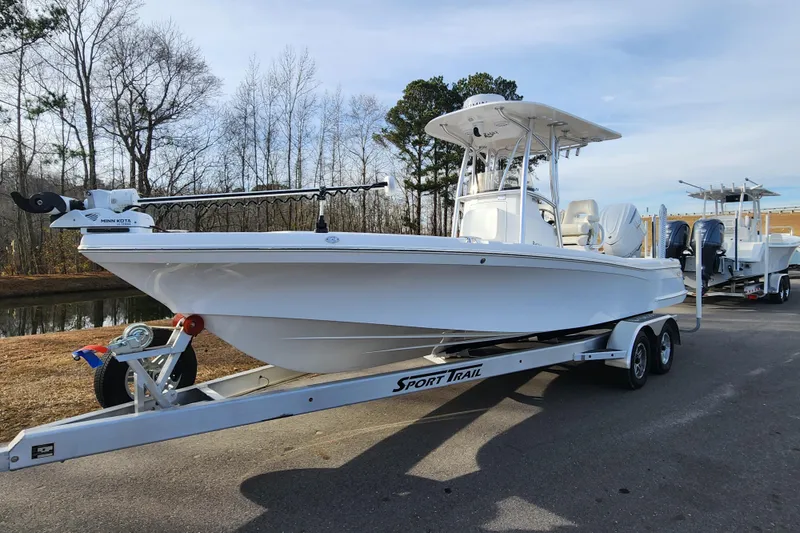 Slide: The Image of 2025 BlackJack 256 Coastal boat on trailer, parked outdoors near trees. - 1