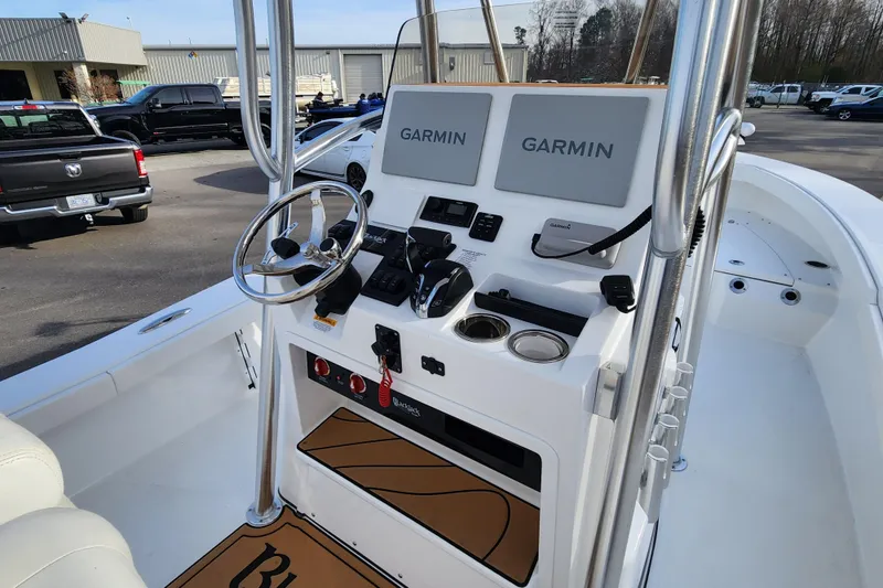 Slide: The Image of 2025 BlackJack 256 Coastal boat console with Garmin navigation systems and steering wheel. - 11