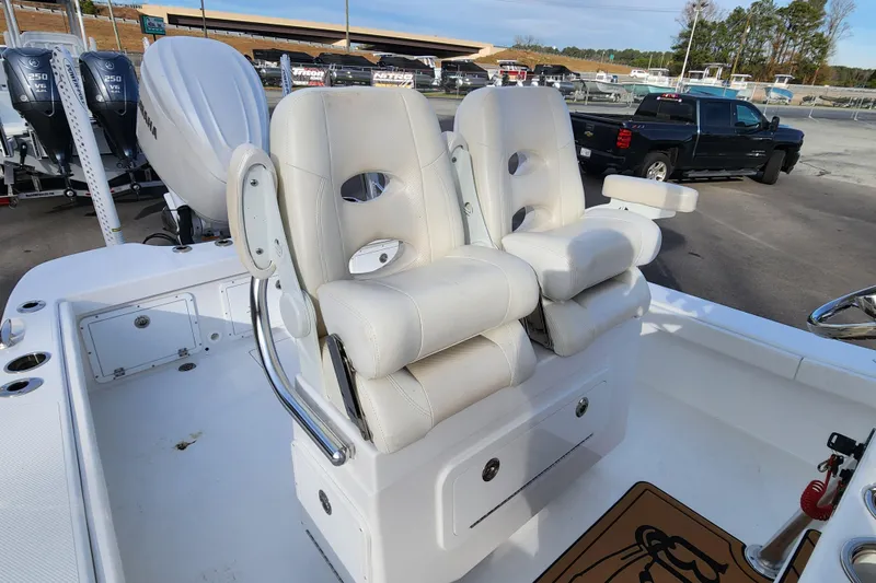 Slide: The Image of 2025 BlackJack 256 Coastal boat with white cushioned seats and Yamaha outboard motors. - 12