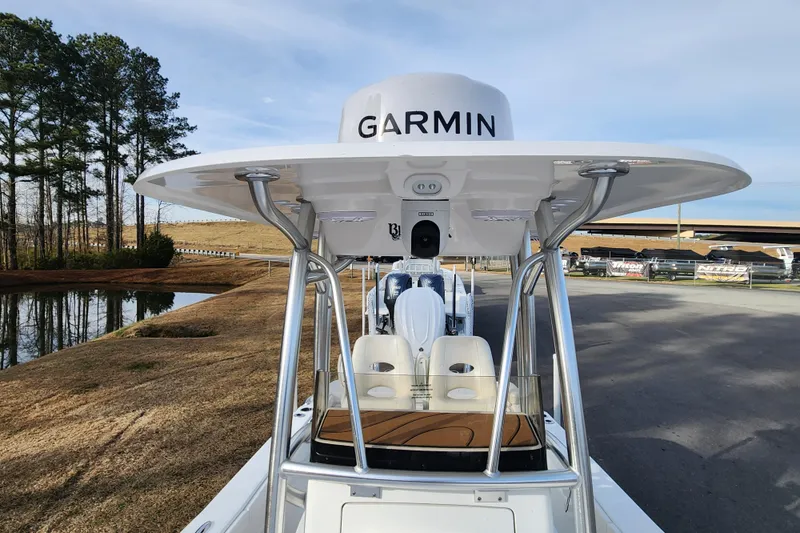 Slide: The Image of 2025 BlackJack 256 Coastal boat with Garmin equipment, parked near a pond and trees. - 14