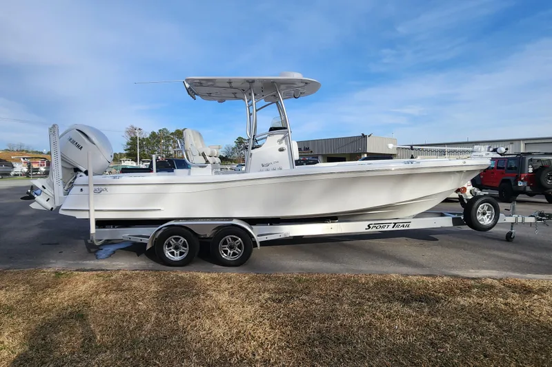 Slide: The Image of 2025 BlackJack 256 Coastal boat on trailer, parked outdoors under clear sky. - 6