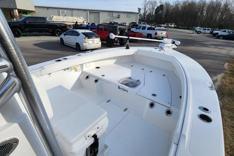Slide: The Image of 2025 BlackJack 256 Coastal boat in parking lot, surrounded by vehicles and trees. - 9