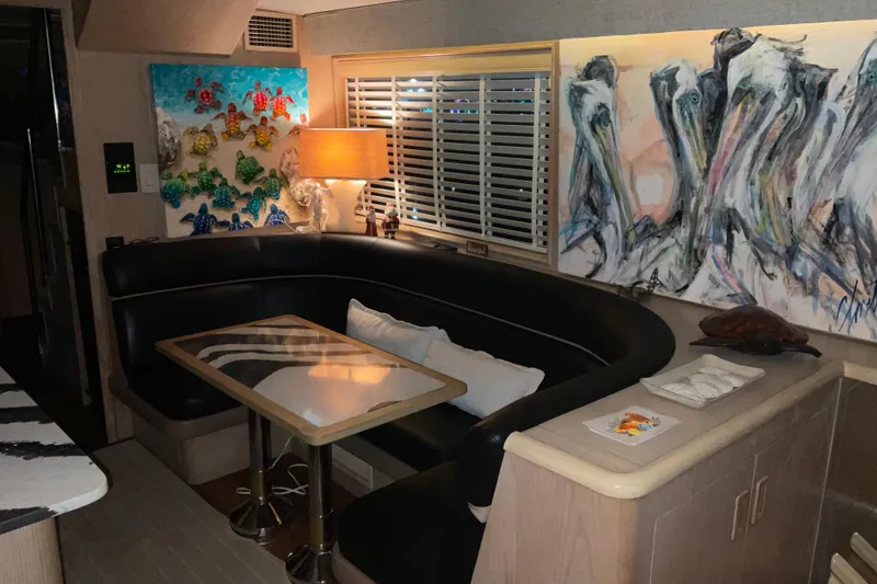 Slide: The Image of Interior of 1997 Hatteras 70 Sport Deck Motor Yacht with art and cozy seating. - 12