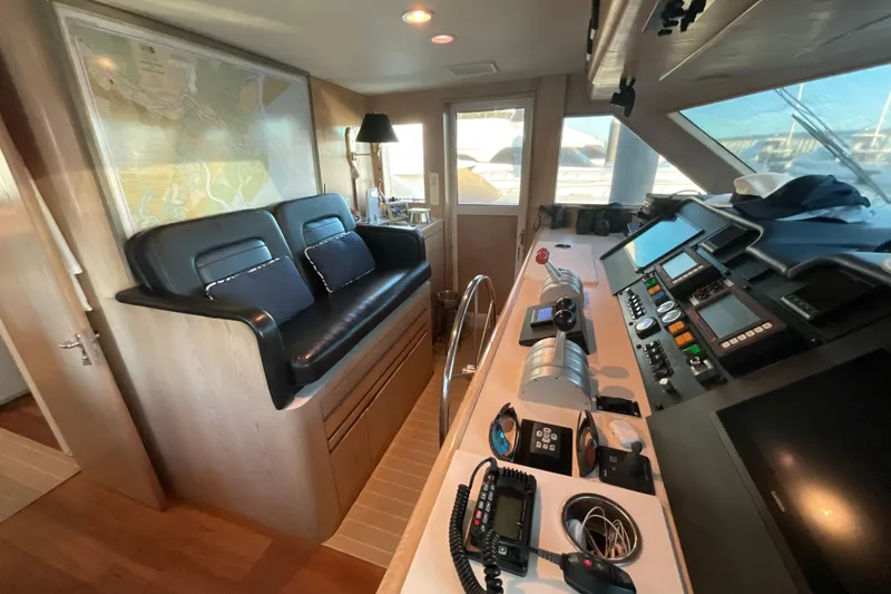 Slide: The Image of Interior of 1997 Hatteras 70 Sport Deck Motor Yacht with navigation equipment and seating. - 13