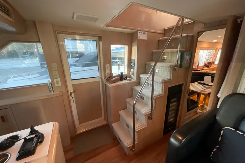 Slide: The Image of Interior of 1997 Hatteras 70 Sport Deck Motor Yacht with stairs and seating area. - 16