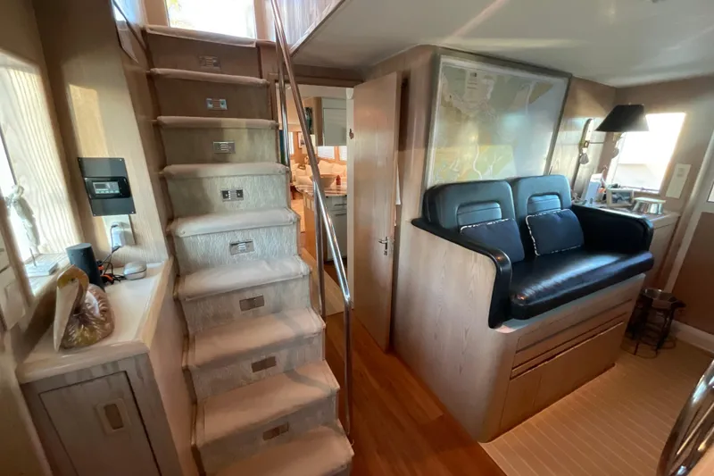 Slide: The Image of Interior of 1997 Hatteras 70 Sport Deck Motor Yacht with stairs and seating area. - 17