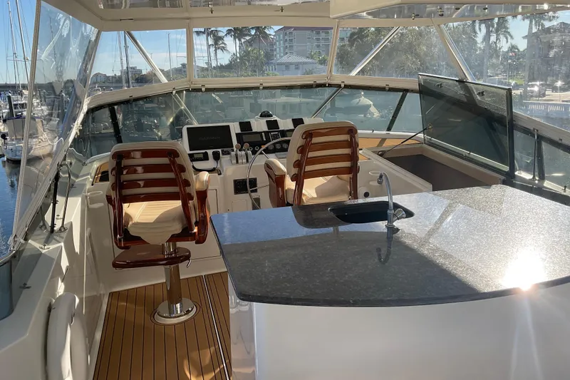 Slide: The Image of Luxurious 1997 Hatteras 70 Sport Deck Motor Yacht helm with modern controls and seating. - 22