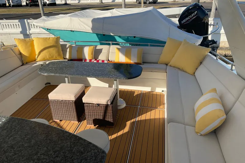 Slide: The Image of Luxurious 1997 Hatteras 70 Sport Deck Motor Yacht with elegant seating and vibrant cushions. - 24