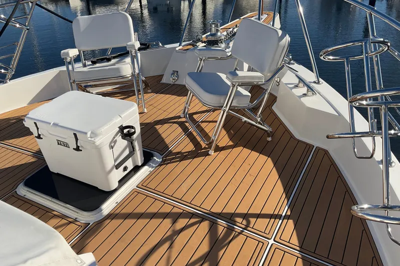 Slide: The Image of 1997 Hatteras 70 Sport Deck Motor Yacht deck with chairs and cooler. - 25