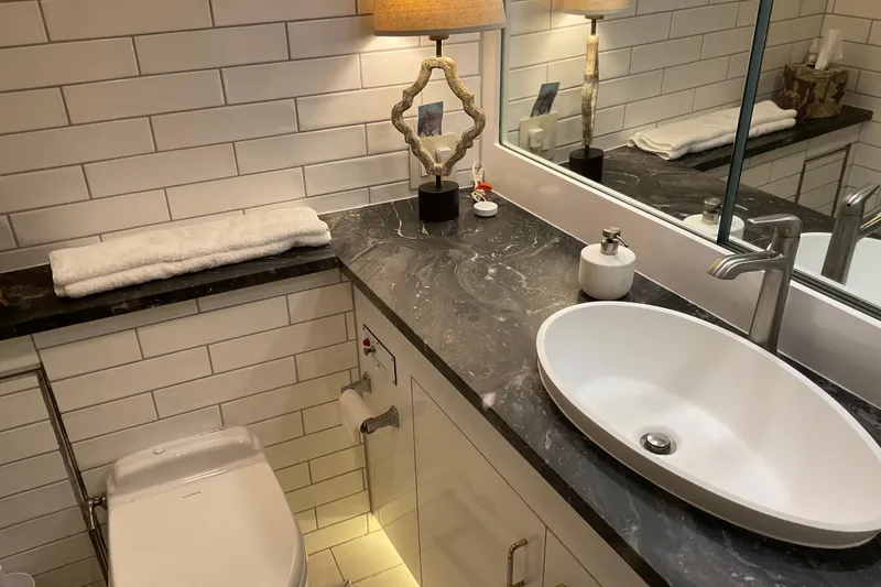 Slide: The Image of Luxurious bathroom in 1997 Hatteras 70 Sport Deck Motor Yacht with modern fixtures and elegant design. - 27