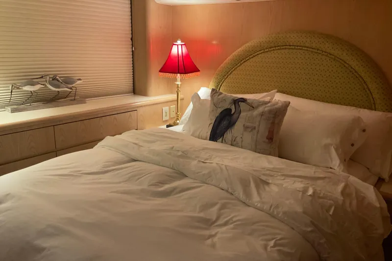 Slide: The Image of Cozy bedroom in 1997 Hatteras 70 Sport Deck Motor Yacht with elegant decor. - 31