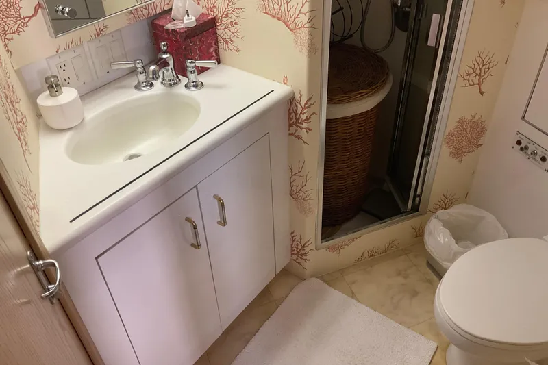 Slide: The Image of Bathroom interior of 1997 Hatteras 70 Sport Deck Motor Yacht with coral-themed wallpaper. - 34